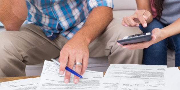 Cropped image of couple calculating finances at home