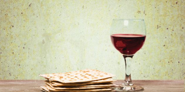 Pesach. Passover background. wine and matzoh (jewish passover bread) over wooden background. vintage effect process.