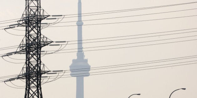 Hydro One power lines cover the view of the CN tower, along with heavy smog, east of downtown Tuesday afternoon. (Photo by Lucas Oleniuk/Toronto Star via Getty Images)