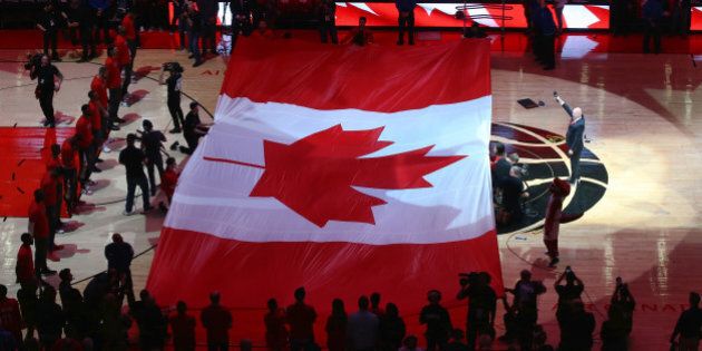 TORONTO, CANADA - APRIL 16: A large Canadian flag is unfurled during the singing of O Canada before the start of the Toronto Raptors game against the Indiana Pacers in Game One of the Eastern Conference Quarterfinals during the 2016 NBA Playoffs on April 16, 2016 at the Air Canada Centre in Toronto, Ontario, Canada. NOTE TO USER: User expressly acknowledges and agrees that, by downloading and or using this photograph, User is consenting to the terms and conditions of the Getty Images License Agreement. (Photo by Tom Szczerbowski/Getty Images)