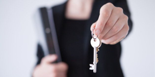Person handing over house keys.