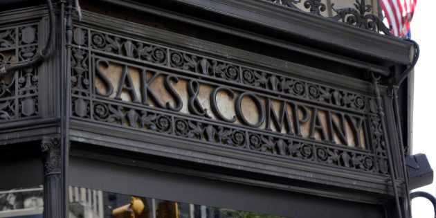 An ironwork logo adorns the facade of Saks flagship store on New York's Fifth Avenue, Monday, July 29, 2013. Saks Inc. agreed to sell itself to Hudson's Bay Co., the Canadian parent of upscale retailer Lord & Taylor, for about $2.4 billion in a deal that will bring luxury to more North American locales. (AP Photo/Richard Drew)