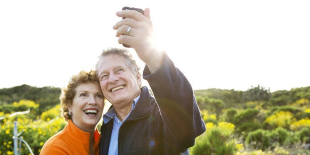 Caucasian couple taking picture outdoors