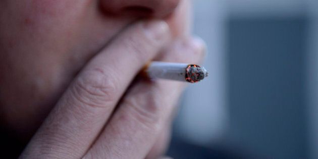 Embargoed to 0001 Monday January 30 File photo dated 12/03/13 of a man smoking a cigarette, as smoking is costing local authorities £760 million a year in social care, a new report warns.