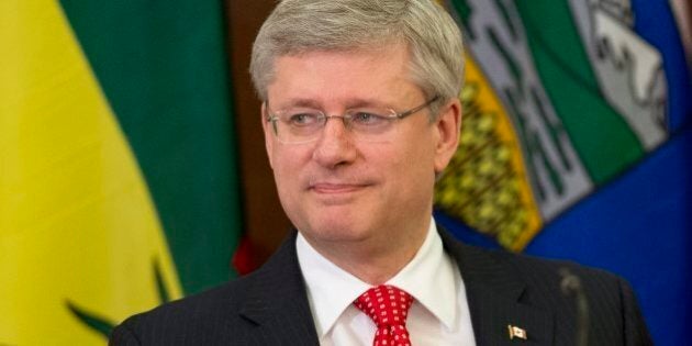 Canadian Prime Minister Stephen Harper looks around as he sits down after speaking to members of Caucus on Parliament Hill Tuesday May 21, 2013 in Ottawa. (AP Photo/THE CANADIAN PRESS/Adrian Wyld)