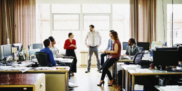 Coworkers in informal group meeting in architects office