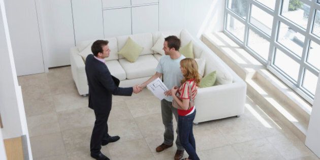 Real Estate Agent With Couple Buying New Apartment