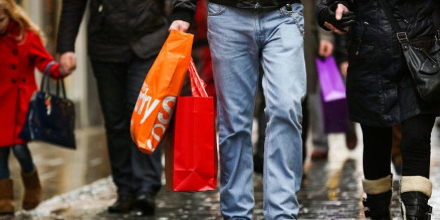 Pedestrians carry shopping bags in the Covent Garden district of London, U.K., on Monday, Dec. 31, 2012. The number of Britons making shopping trips for post-holiday bargains barely increased on the day after Christmas as more people sought discounts online. Photographer: Jason Alden/Bloomberg via Getty Images