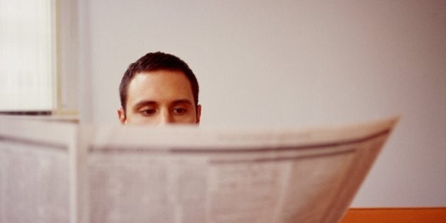 Young Man Reading Newspaper