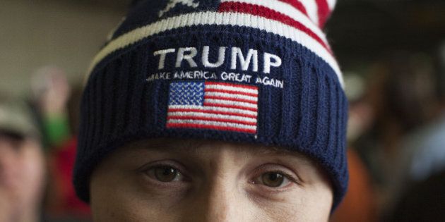 An attendee wears a hat in support of Donald Trump, president and chief executive of Trump Organization Inc. and 2016 Republican presidential candidate, not pictured, during a campaign rally at the Port Columbus International Airport in Columbus, Ohio, U.S., on Tuesday, March 1, 2016. State officials were reporting strong turnout for Super Tuesday balloting, the closest thing yet to a national referendum on Trump, the brash New York billionaire who has thrown out the traditional rules of campaigning. Photographer: Ty Wright/Bloomberg via Getty Images