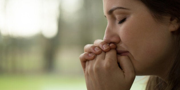 Horizontal view of depressed young woman crying