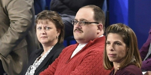 (FILES) In this file photo dated October 9, 2016 Ken Bone (C) listens to US Democratic nominee Hillary Clinton and Republican nominee Donald Trump during the second presidential debate at Washington University in St. Louis, Missouri. As the mud flew at Donald Trump and Hillary Clinton's second presidential debate Sunday, the American everyman became an instant celebrity by calmly asking a question about energy policy. Bone -- even his sturdy name has been a source of amusement on social media -- had been picked to represent undecided voters at the town hall-style debate in St Louis, Missouri. His heft, poise and polite manner offered a brief but refreshing respite from the 90-minute slug-fest between the Republican and Democratic candidates. / AFP / POOL / Paul J. Richards / TO GO WITH AFP STORY 'Ken Bone, everyman hero in a tawdry US campaign' (Photo credit should read PAUL J. RICHARDS/AFP/Getty Images)