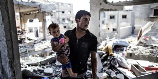 A Palestinian man looks on while standing in what remains of his house in part of the northern Beit Hanun district of the Gaza Strip after a 72-hour truce accepted by Israel and Hamas came into effect on August 5, 2014. Israel and Hamas said they have agreed a new 72-hour truce, after increasingly vocal international demands for a ceasefire in the bloody 29-day-old Gaza conflict. AFP PHOTO/MARCO LONGARI (Photo credit should read MARCO LONGARI/AFP/Getty Images)