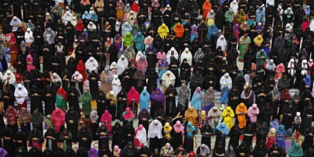 Indian Muslim women offer prayers on Eid al-Fitr in Chennai, India, Friday, Aug. 9, 2013. Eid al-Fitr marks the end of the holy month of Ramadan, during which Muslims all over the world fast from sunrise to sunset. (AP Photo/Arun Sankar K.)