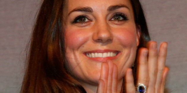 Britain's Duchess of Cambridge, left, Patron of SportsAid charity, applauds shooter Amber Hill, 16, after she presented her with the charity's this year One-to-Watch Award during the SportsBall, the charity's annual gala dinner, in London, Thursday, Nov. 28, 2013. Hill was chosen from more than 1,300 athletes who have been supported by SportsAid this year, by giving them financial support and recognition during the critical early years of their careers. (AP Photo/Lefteris Pitarakis, pool)