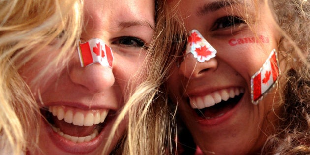 Canada supporters celebrate in downtown Vancouver following the Canadian's ice hockey team's victory over the USA in extra time on February 28, 2010. With some seeing Canada playing the US as the highlight of the Winter Games, the host country went on to take the gold medal on the final day of the Olympics.. AFP PHOTO / VINCENZO PINTO (Photo credit should read VINCENZO PINTO/AFP/Getty Images)