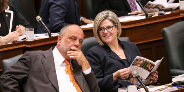 TORONTO, ON- MAY 1 - NDP leader Andrea Horwath talks with seat mate Gilles Bisson while Ontario Minister of Finance Charles Sousa delivers the budget speech in the Legislative Assembly of Ontario during the reading of the Budget at Queen's Park May 1, 2014. (David Cooper/Toronto Star via Getty Images)