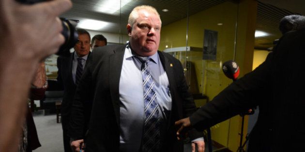 TORONTO, ON - NOVEMBER 13 - Mayor Rob Ford's surrounded by media leaves his office with security and lawyer Dennis Morris at City Hall in Toronto on November 13, 2013 (Vince Talotta/Toronto Star via Getty Images)