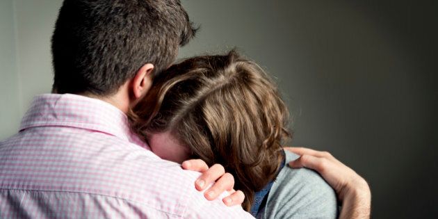 Couple embracing after receiving some bad news.