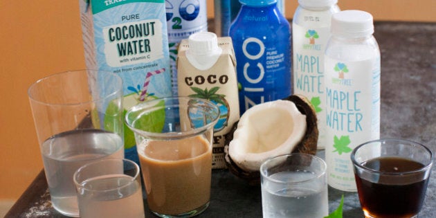 This June 9, 2014 photo shows an assortment of trending waters from left to right Trader Joe's pure coconut water, C2O pure coconut water, Coco Cafe vanilla coconut water cafe latte, Zico pure premium coconut water, O.N.E. coconut water, and Happy Tree maple water and maple syrup in Concord, N.H. Coconut water, maple water and a range of enhanced waters are being touted as a healthier alternative to sugary soda. (AP Photo/Matthew Mead)