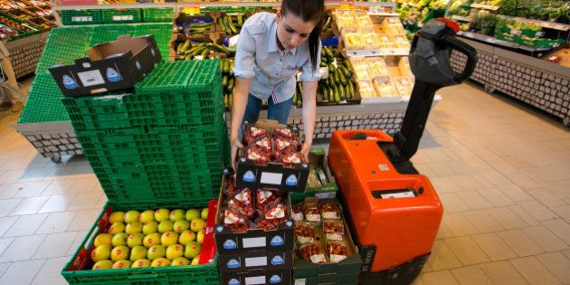 An employee unloads punnets of strawberries from a pallet inside a Rewe supermarket, operated by the Rewe Group, in Berlin, Germany, on Tuesday, April 29, 2014. Berlin retail sales adjusted for inflation climbed 5.8 percent last year, according to the city's statistics office, compared with a rise of just 0.1 percent in Germany as a whole. Photographer: Krisztian Bocsi/Bloomberg via Getty Images