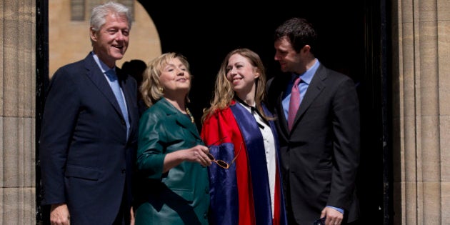 Former U.S. Secretary of State Hillary Rodham Clinton, second left, takes off her sunglasses to pose for a group photograph with her husband former U.S. President Bill Clinton, left, their daughter Chelsea, second right, and her husband Marc Mezvinsky, as they leave after they all attended Chelsea's Oxford University graduation ceremony at the Sheldonian Theatre in Oxford, England, Saturday, May 10, 2014. Chelsea Clinton received her doctorate degree in international relations on Saturday from the prestigious British university. Her father was a Rhodes scholar at Oxford from 1968 to 1970. The graduation ceremony comes as her mother is considering a potential 2016 presidential campaign. (AP Photo/Matt Dunham)