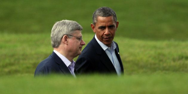 ENNISKILLEN, NORTHERN IRELAND - JUNE 18: US President Barack Obama (R) talks with Canadian Prime Minister Stephen Harper following the 'family' group photograph at the G8 venue of Lough Erne on June 18, 2013 in Enniskillen, Northern Ireland. The two day G8 summit, hosted by UK Prime Minister David Cameron, is being held in Northern Ireland for the first time. Leaders from the G8 nations have gathered to discuss numerous topics with the situation in Syria expected to dominate the talks. (Photo by Matt Cardy/Getty Images)