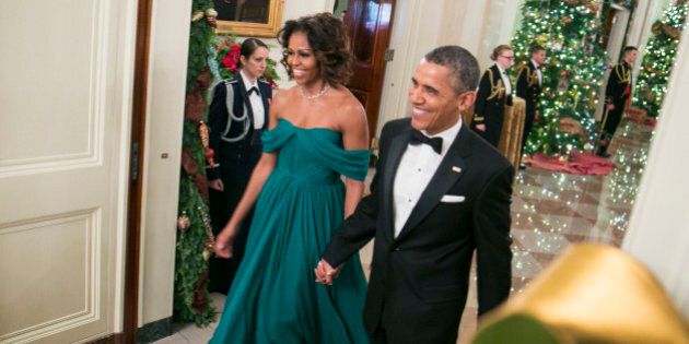 WASHINGTON, DC - DECEMBER 08: President Barack Obama (R) and First Lady Michelle Obama arrive for a reception at the White House for the 2013 Kennedy Center Honorees on December 8, 2013 in Washington, DC. The honorees this year include: opera singer Martina Arroyo, jazz musician Herbie Hancock, musician Billy Joel, actress Shirley MacLaine and musician Carlos Santana. (Photo by Kristoffer Tripplaar-Pool/Getty Images)