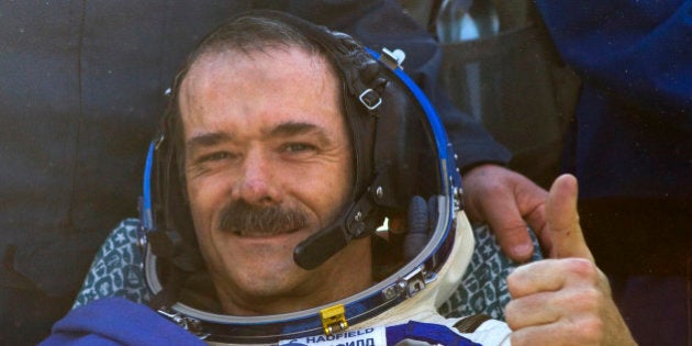 Canadian astronaut Chris Hadfield gestures after the Russian Soyuz space capsule landed some 150 kilometers (94 miles) southeast of the town of Dzhezkazgan in central Kazakhstan, Tuesday, May 14, 2013. The Soyuz space capsule carrying a three-man crew returning from a five-month mission to the International Space Station landed safely Tuesday on the steppes of kazakhstan. (AP Photo/ Sergei Remezov, Pool)