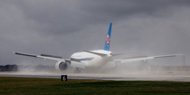 A China Southern Airlines Co. cargo jet lands at O'Hare International Airport during an event to mark the opening of a new runway in Chicago, Illinois, U.S. on Thursday, Oct. 17, 2013. The total cost of Runway 10 Center/28 Center (10C-28C) was $1.3 billion and will allow the airport to increase landings per hour from 88 to 106, according to the Chicago Department of Aviation. Photographer: Tim Boyle/Bloomberg via Getty Images