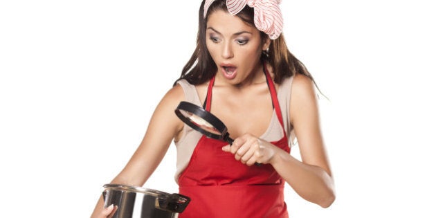 shocked pretty housewife looking through the lens of her pot with