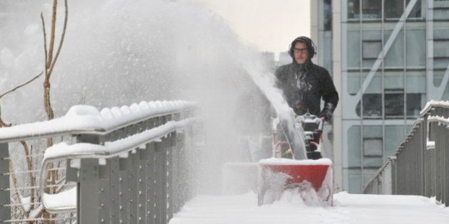 Workers remove snow from the Falcone Flyover at the High Line after the blizzard.