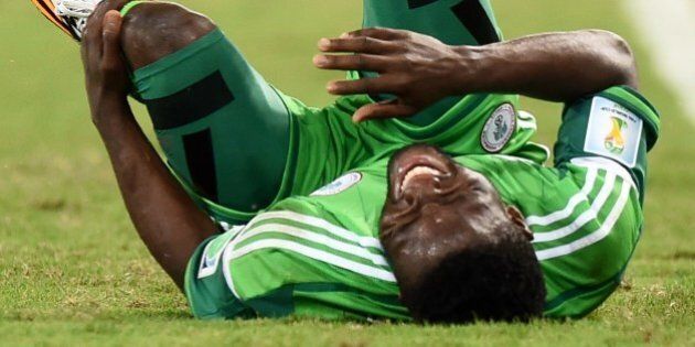 Nigeria's forward Michael Babatunde reacts in pain after falling during the Group F football match between Nigeria and Bosnia-Hercegovina at the Pantanal Arena in Cuiaba during the 2014 FIFA World Cup on June 21, 2014. AFP PHOTO / JEWEL SAMAD (Photo credit should read JEWEL SAMAD/AFP/Getty Images)
