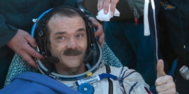 Canadian spaceman Chris Hadfield gives a thumb up shortly after the landing aboard the Russian Soyuz space capsule some 150 km (90 miles) southeast of the town of Zhezkazgan in central Kazakhstan on May 14, 2013. US astronaut Tom Marshburn, Canadian spaceman Chris Hadfield and Russian cosmonaut Roman Romanenko returned today to Earth aboard a Russian Soyuz-TMA capsule after a half-year mission to the International Space Station, Moscow mission control said. AFP PHOTO / POOL /MIKHAIL METZEL (Photo credit should read MIKHAIL METZEL/AFP/Getty Images)