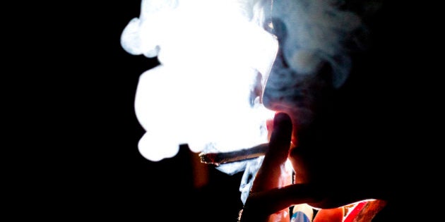 A woman smokes a marijuana cigarette in Toronto, Ontario, Canada, on Wednesday, Oct. 26, 2011.Ontario is one step closer to the legalization of marijuana after the Ontario Superior Court struck down two key parts of the Controlled Drugs and Substances Act that prohibit the possession and production of pot in April, according to the National Post. Photographer: Brent Lewin/Bloomberg via Getty Images