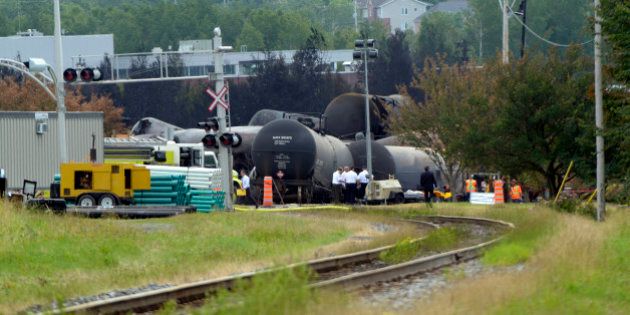Investigators work at the train derailment site July 9, 2013 in Lac-megantic, Quebec, Canada. The death toll from the massive explosion caused by a runaway oil tanker train that derailed July 6 and flattened part of the small Canadian town has risen to 13, a coroner said Monday, and dozens more remain missing. Confirmation of eight further deaths in Lac-Megantic, in Quebec province, came as environmental officials warned that around 100,000 liters of oil spilled in the disaster was headed for the Saint Lawrence seaway. PHOTO STEEVE DUGUAY-AFP (Photo credit should read STEEVE DUGUAY/AFP/Getty Images)