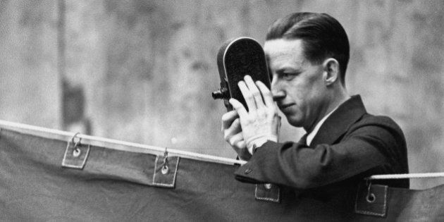 Jack Purcell, the Canadian champion, uses his cine-camera to record the play at the All England Badminton Championships in the Royal Horticultural Hall, Westminster, 2nd March 1931. (Photo by Topical Press Agency/Hulton Archive/Getty Images)