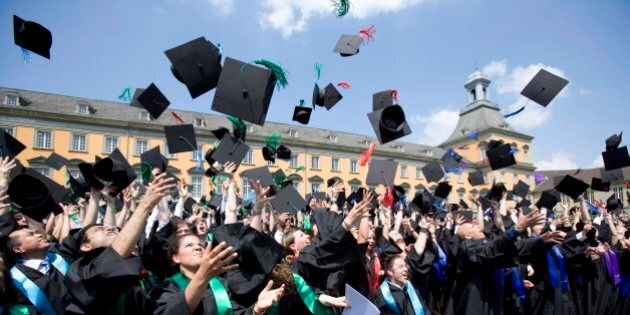 GERMANY, BONN - JULY 6: Graduates with robes and birettas are throwing their birettas into the air at the 9th celebration of the Rheinische-Friedrich-Wilhelms University in Bonn at July 6, 2013 in Bonn, Germany. (Photo by Ulrich Baumgarten via Getty Images)