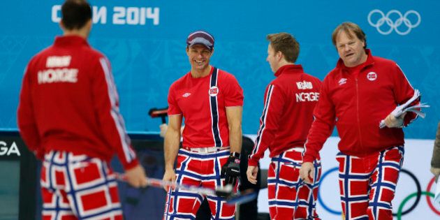 Norway skip Thomas Ulsrud, second from left, and teammate Torger Nergaard, second from right, share a laugh during a men's curling training session the 2014 Winter Olympics, Sunday, Feb. 9, 2014, in Sochi, Russia. At right is coach Paal Trulsen. (AP Photo/Robert F. Bukaty)