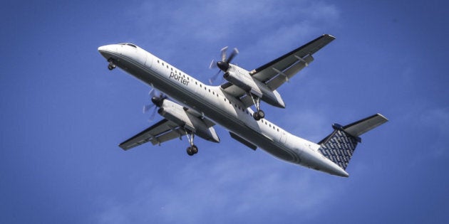 TORONTO, ON- AUGUST 27 - A Porter airlines Q400 with it's wheels down on final approach passes over Cherry Beach en route to Billy Bishop Toronto City Airport. August 27, 2014. (David Cooper/Toronto Star via Getty Images)