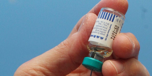 A nurse uses a syringe to prepare an injection of the combined Measles Mumps and Rubella (MMR) vaccination at an MMR drop-in clinic at Neath Port Talbot Hospital near Swansea in south Wales on April 20, 2013. Public health officials said on April 19 they were investigating the first suspected death from measles in Britain in five years, after an outbreak blamed on a campaign against vaccinations. More than 800 people have contracted the highly contagious disease in Wales in the past six months, centred around the southern city of Swansea. Marion Lyons, director of health protection for Wales, said it had now been confirmed that a 25-year-old man from Swansea who died on April 18 had measles, a full postmortem will be conducted to determine cause of death. AFP PHOTO / GEOFF CADDICK (Photo credit should read GEOFF CADDICK/AFP/Getty Images)