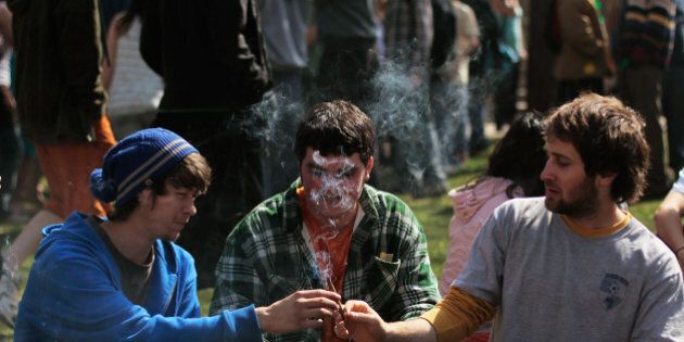 BOULDER, CO - APRIL 20: Young men smoke a marijuana cigarette during a 'smoke out' with thousands of others April 20, 2010 at the University of Colorado in Boulder, Colorado. April 20th has become a de facto holiday for marijuana advocates, with large gatherings and 'smoke outs' in many parts of the United States. Colorado, one of 14 states to allow use of medical marijuana, has experienced an explosion in marijuana dispensaries, trade shows and related businesses in the last year as marijuana use becomes more mainstream here. (Photo by Chris Hondros/Getty Images)