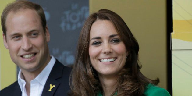 Kate, Duchess of Cambridge and Prince William watch the podium ceremony of the first stage of the Tour de France cycling race over 190.5 kilometers (118.4 miles) with start in Leeds and finish in Harrogate, England, Saturday, July 5, 2014. (AP Photo/Laurent Cipriani)