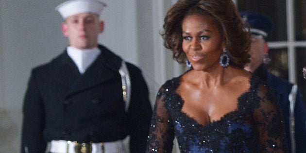 US President Barack Obama, First Lady Michelle Obama pose with French President Francois Hollande as he arrives for the State Dinner at the North Portico of the White House on February 11, 2014 in Washington, DC. AFP PHOTO/Mandel NGAN (Photo credit should read MANDEL NGAN/AFP/Getty Images)