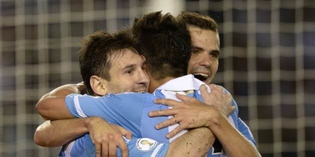 TOPSHOTS Argentina's forward Lionel Messi (L) celebrates with teammates forward Ezequiel Lavezzi (C) and midfielder Fernando Gago after shooting a penalty to score his team's second goal against Venezuela during a Brazil 2014 World Cup South American qualifier football match at the Monumental stadium in Buenos Aires, on March 22, 2013. AFP PHOTO / Juan Mabromata (Photo credit should read JUAN MABROMATA/AFP/Getty Images)