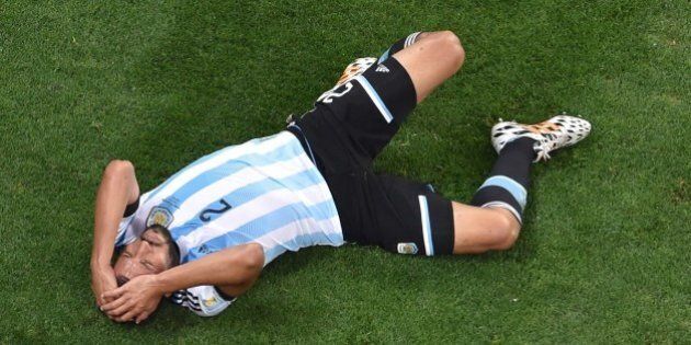 Argentina's defender Ezequiel Garay gestures in pain during the semi-final football match between Netherlands and Argentina of the FIFA World Cup at The Corinthians Arena in Sao Paulo on July 9, 2014. AFP PHOTO / POOL / FRANCOIS XAVIER MARIT (Photo credit should read FRANCOIS XAVIER MARIT/AFP/Getty Images)