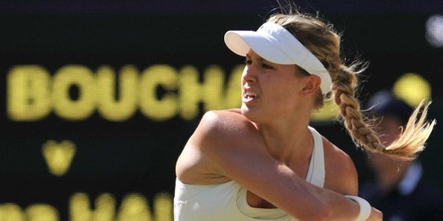 Canada's Eugenie Bouchard returns to Romania's Simona Halep during their women's singles semi-final match on day ten of the 2014 Wimbledon Championships at The All England Tennis Club in Wimbledon, southwest London, on July 3, 2014. AFP PHOTO / GLYN KIRK - RESTRICTED TO EDITORIAL USE (Photo credit should read GLYN KIRK/AFP/Getty Images)