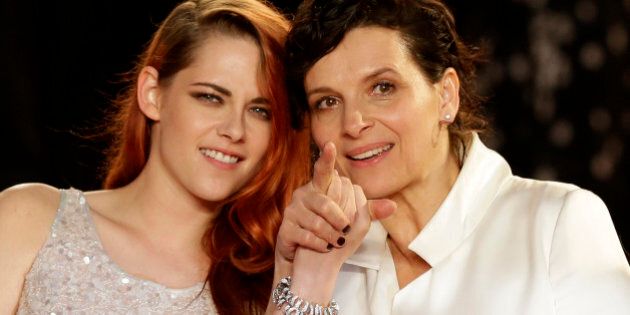 Actress Kristen Stewart, left, and actress Juliette Binoche pose for photographers following the screening of Sils Maria at the 67th international film festival, Cannes, southern France, Friday, May 23, 2014. (AP Photo/Thibault Camus)