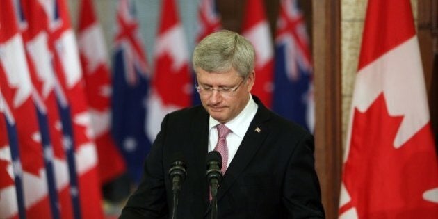 Canadian Prime Minister Stephen Harper pauses as he address the media alongside Australian Prime Minister Tony Abbott(not shown) on Parliament Hill in Ottawa, Canda, June 9, 2014. AFP PHOTO/ Cole BURSTON (Photo credit should read Cole Burston/AFP/Getty Images)