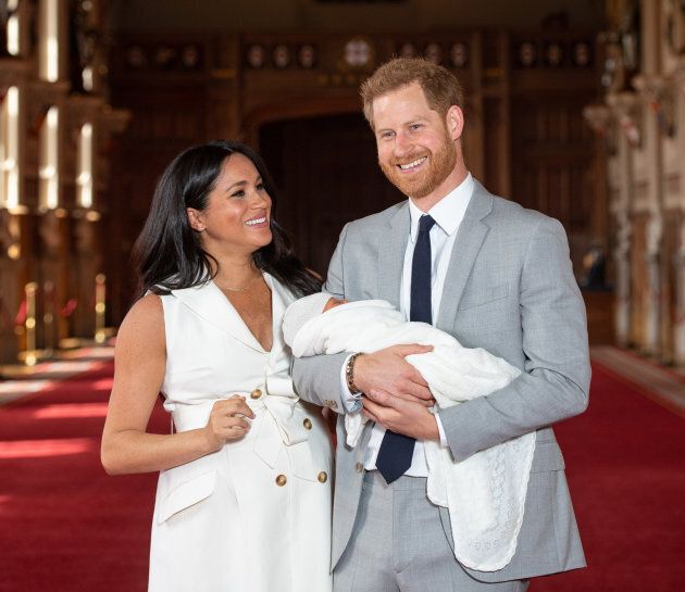 Prince Harry, Duke of Sussex and Meghan, Duchess of Sussex, pose with their newborn son Prince Archie Harrison Mountbatten-Windsor in St George's Hall at Windsor Castle on May 8, 2019 in Windsor, England.